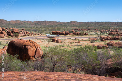 Vans on road trip parked at Devils Marbles parking spot. Sacred place for aboriginal people, with massive granite boulders. Aboriginal name Karlu Karlu. Tennant Creek, Australia photo