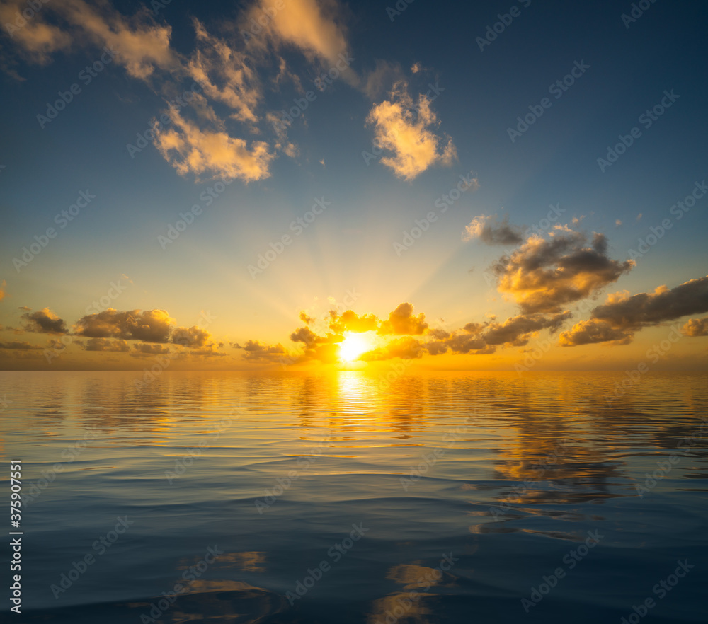 Dramatic sunrise or sunset reflected into the calm waters of an artificial ocean to represent peace or heaven