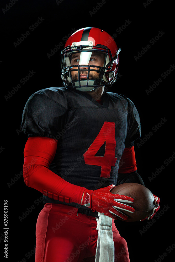 American football player, athlete sportsman in red helmet on black background. Sport and motivation wallpaper.