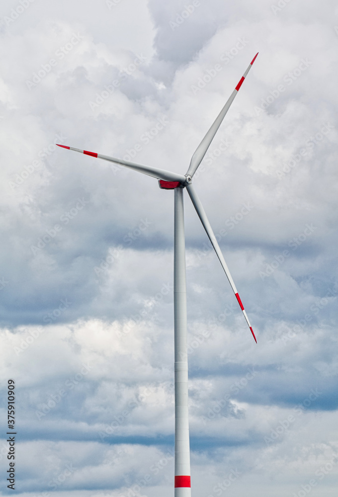 wind turbine against cloudy sky