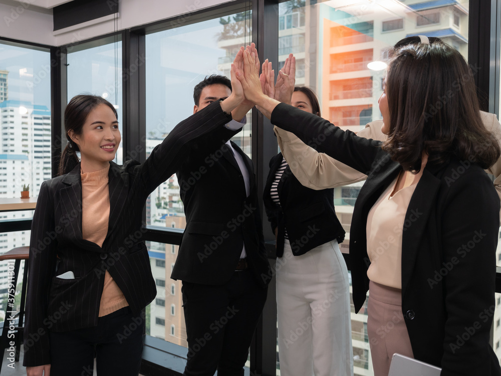 Group of diverse people multiethnic unity togetherness in the Volunteer community. Multi-ethnic corporate office business team winners join hands give high five together . Group of diverse people multiethnic unity togetherness in the Volunteer community. Multi-ethnic corporate office business team winners join hands give high five together .