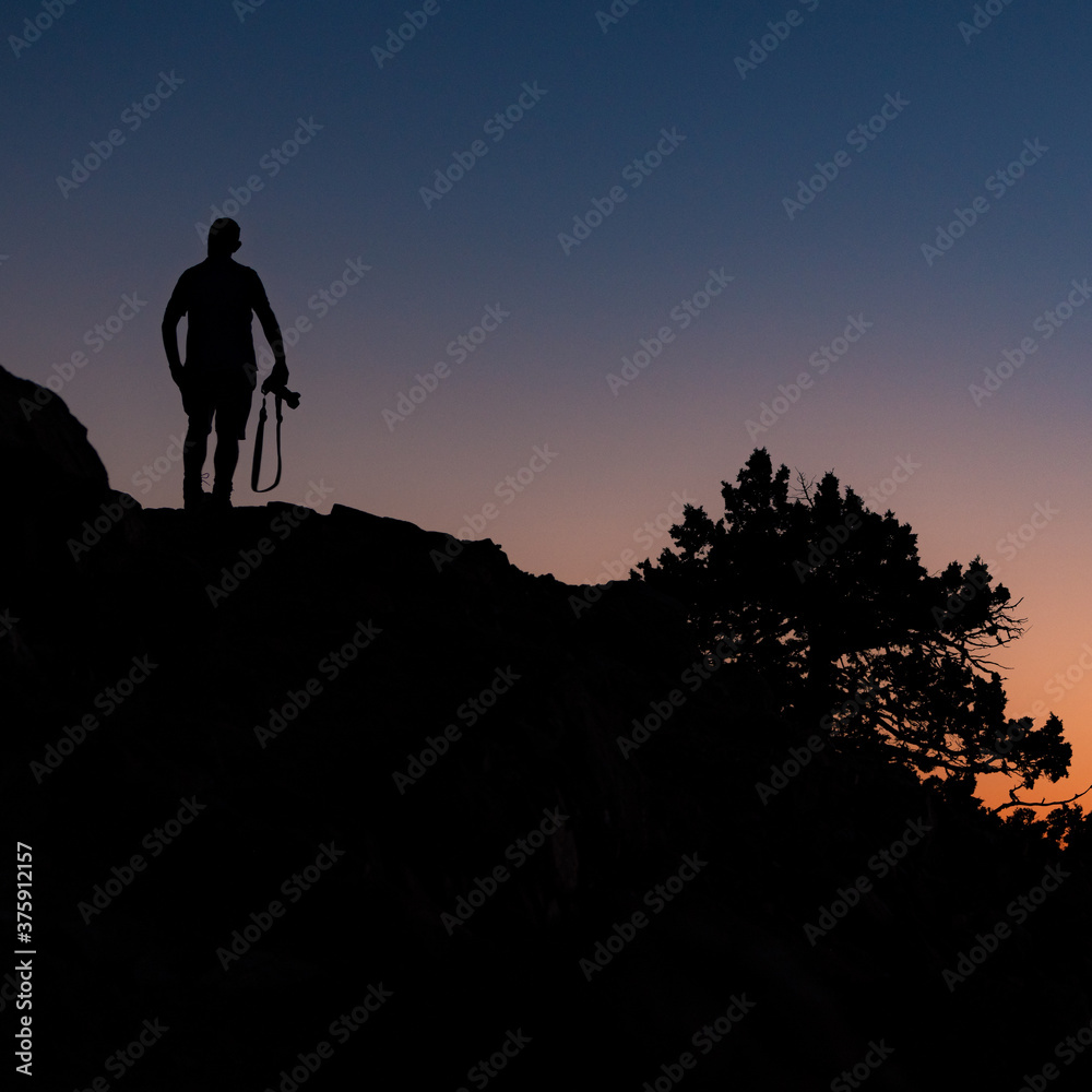 silhouette of a person with a camera on the top of a mountain at Troodos mountain in Cyprus
