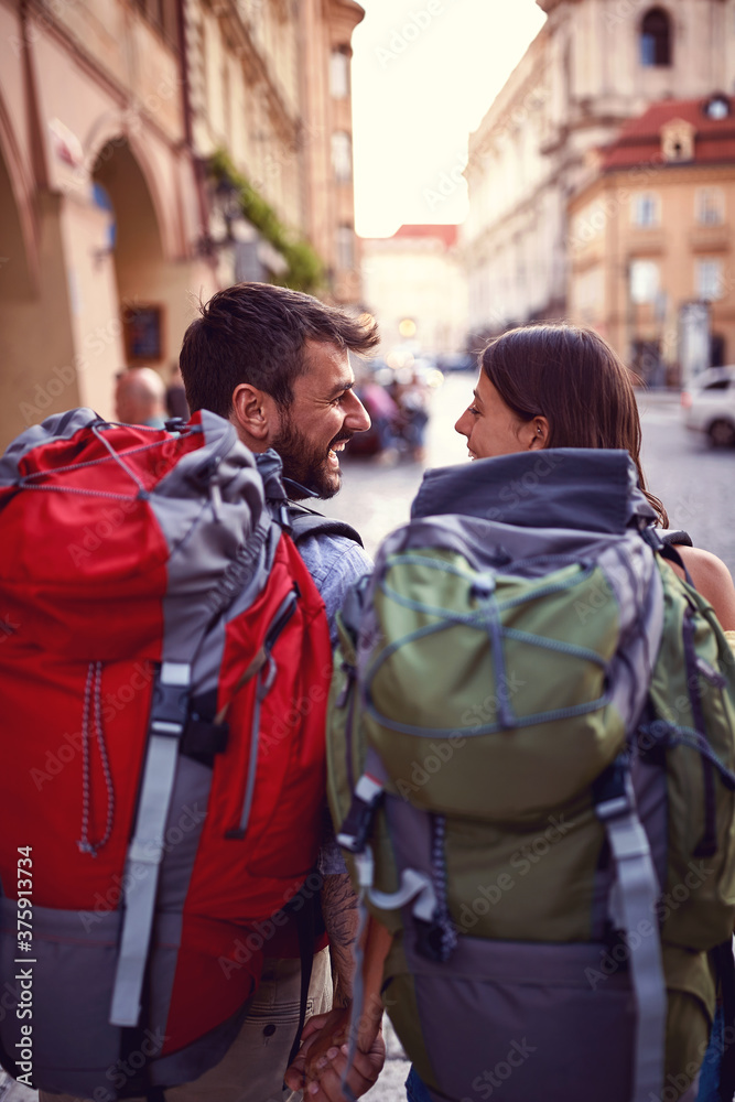 Young backpackers couple satisfied about the city