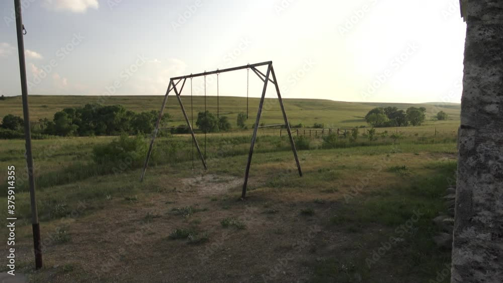 a swing set in the evening on the prairie a swing set in the evening on the prairie