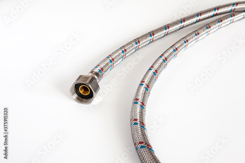 Flexible water hose. Metal braided flexible water hose for sanitary installation. Isolated on white background.