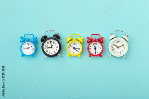 Clocks with various time and color on blue background