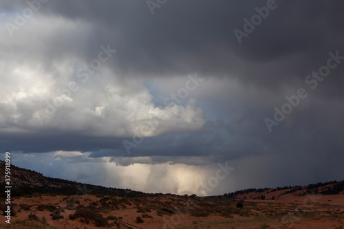 Stormy sky and clouds before sunset above the Coral Pink Sand Dunes State Park near Kanab, Utah, USA
