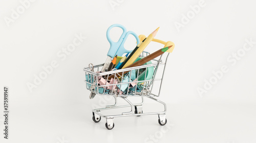 Trolley with school equipment on white background