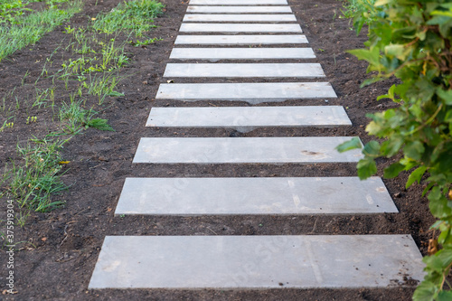 Step path made of concrete slabs in the Park. Step-by-step concrete path