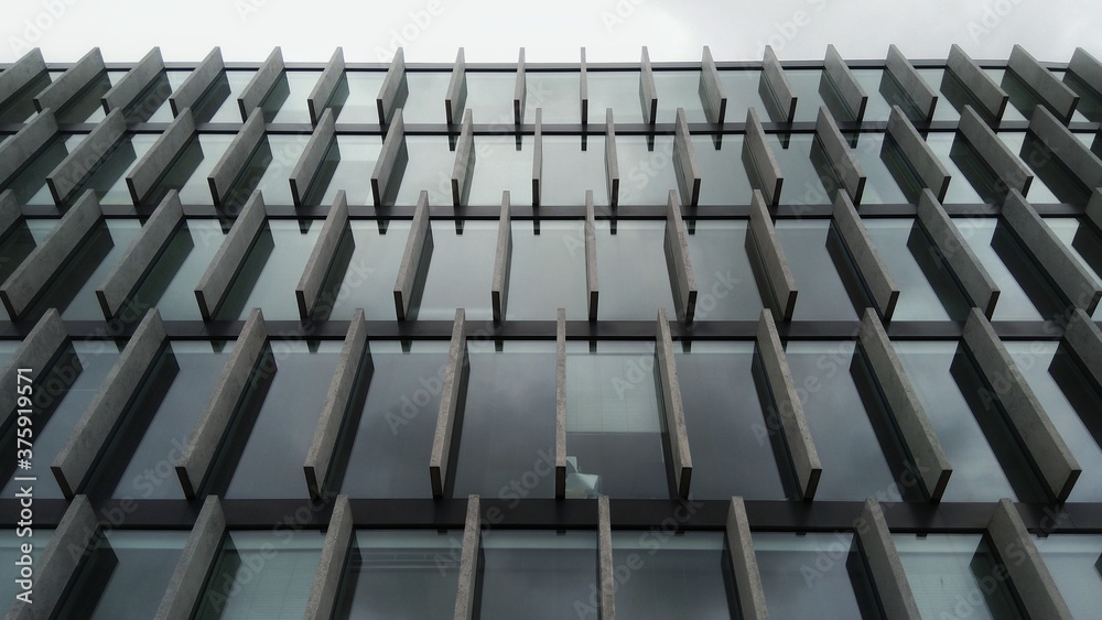 Fototapeta premium Black and white modern office building glass and concrete wall