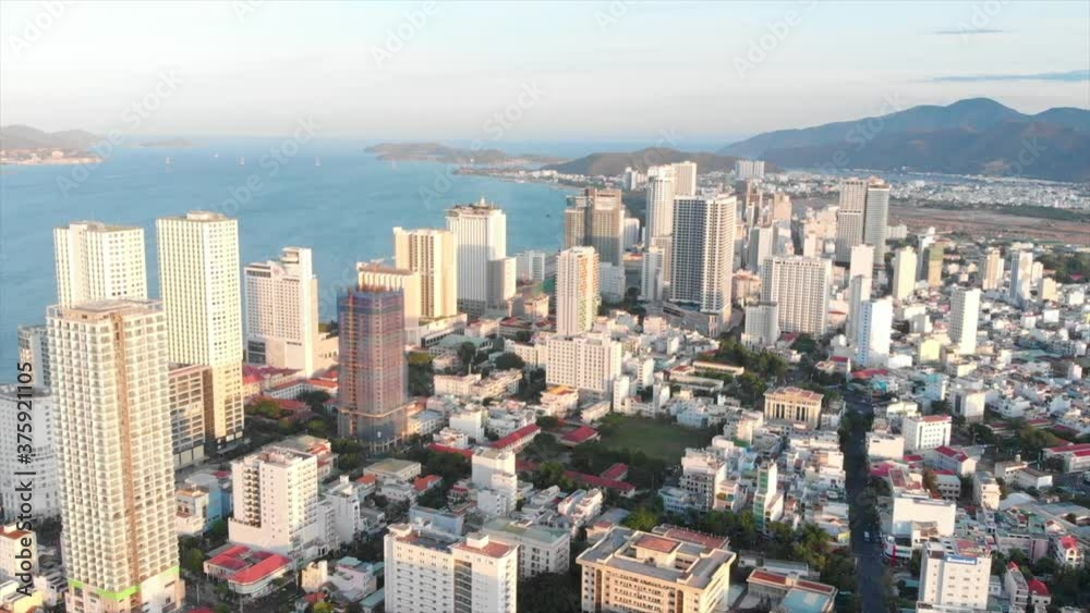 Drones aerial take a beautiful view of the big city from a bird's eye view with skyscrapers or tall buildings against the backdrop of a beautiful blue sea. 4K. Drones aerial take a beautiful view of the big city from a bird's eye view with skyscrapers or tall buildings against the backdrop of a beautiful blue sea. 4K.