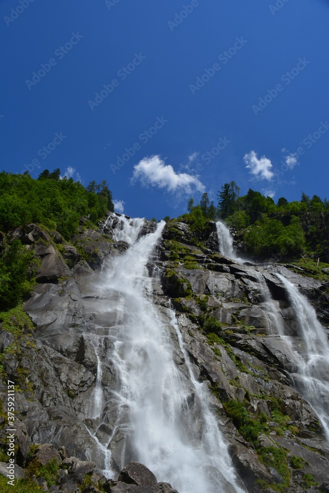 waterfall in the mountains with trees and blue sky no people copy space waterfall in the mountains with trees and blue sky no people copy space