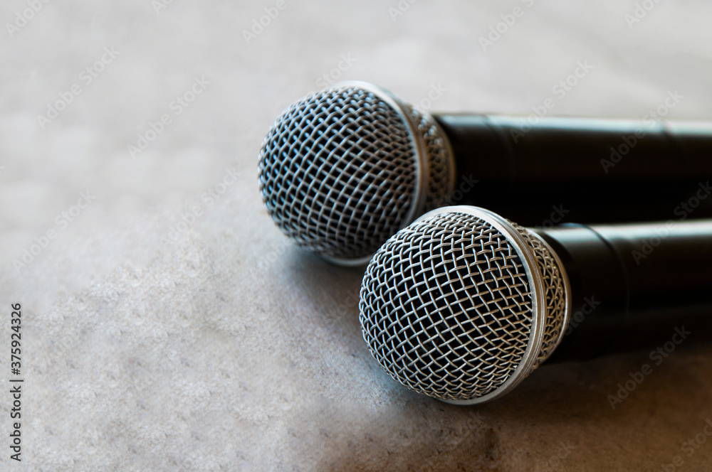 Obraz premium two microphones on a gray background. radio microphones in the studio. music equipment