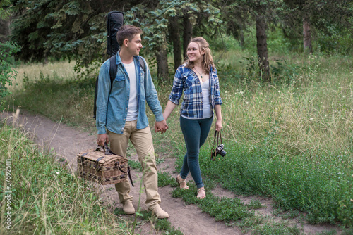 young couple walking in the woods