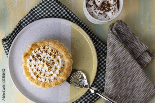 Lemon pie with cappuccino cup of coffee