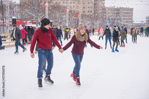 young couple ice skating © Ksenia Belyaeva