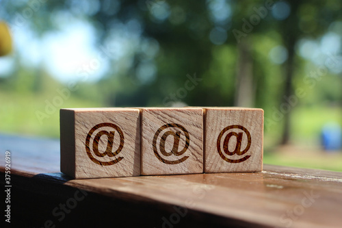 Woden cubes with eta sign on wooden table outdoors. Online cources concept photo