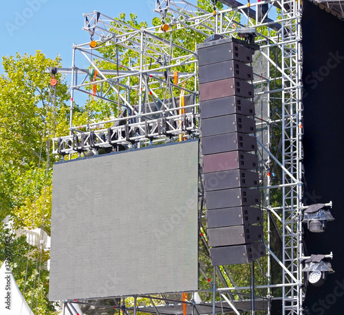 speakers hanging for an outdoor concert photo