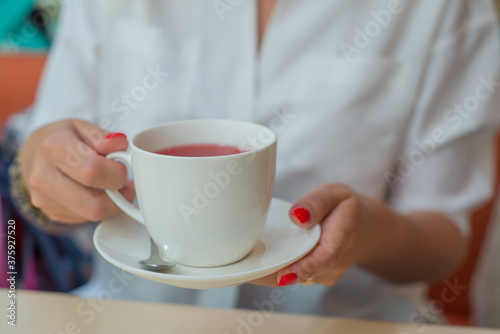 woman holding cup of tea