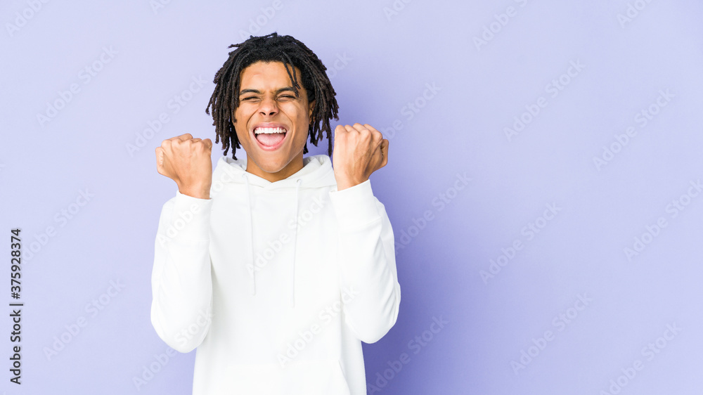 Young african american rasta man cheering carefree and excited. Victory concept. Young african american rasta man cheering carefree and excited. Victory concept.