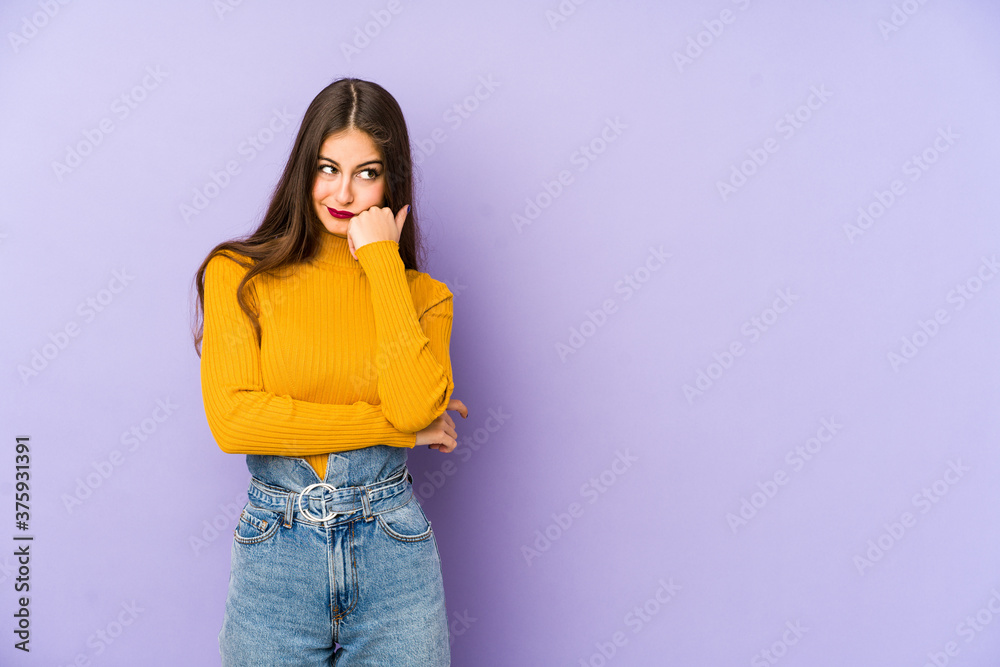 Young caucasian woman isolated on purple background who feels sad and pensive, looking at copy space. - obrazy, fototapety, plakaty 