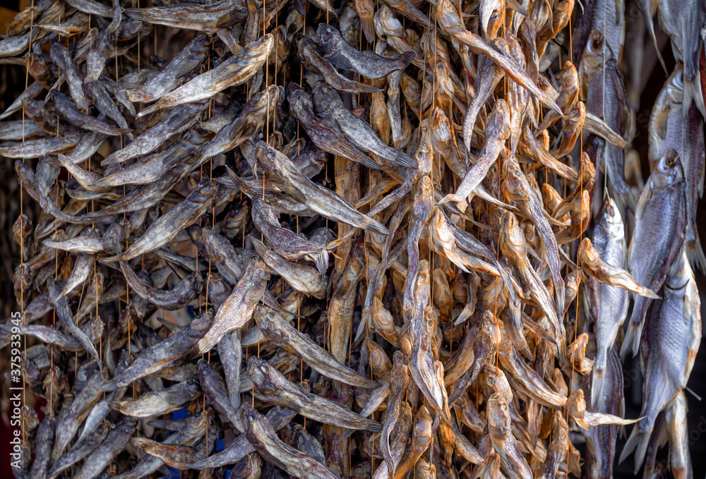 Bundles of dried salted goby or bullhead fish for sale at outdoors seafood market Bundles of dried salted goby or bullhead fish for sale at outdoors seafood market