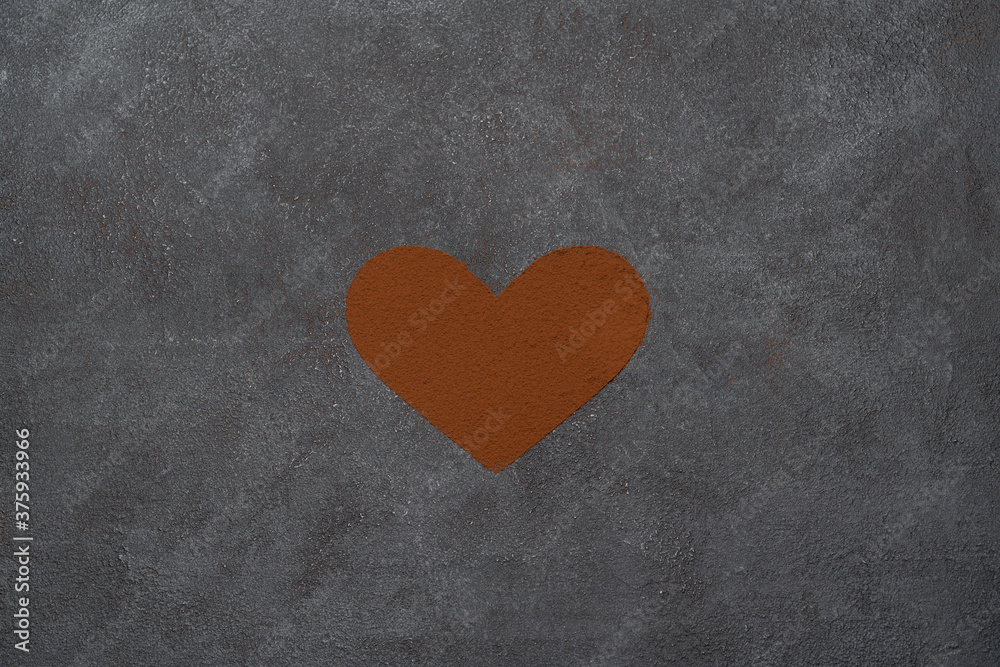 Heart shape of spreading cocoa powder onc oncrete background Heart shape of spreading cocoa powder onc oncrete background