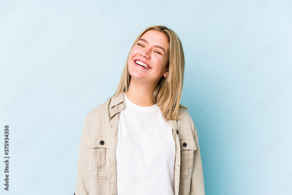 Young blonde caucasian woman isolated relaxed and happy laughing, neck stretched showing teeth. Young blonde caucasian woman isolated relaxed and happy laughing, neck stretched showing teeth.