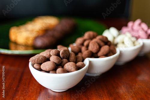Almond nuts in dark, milk chocolate. 