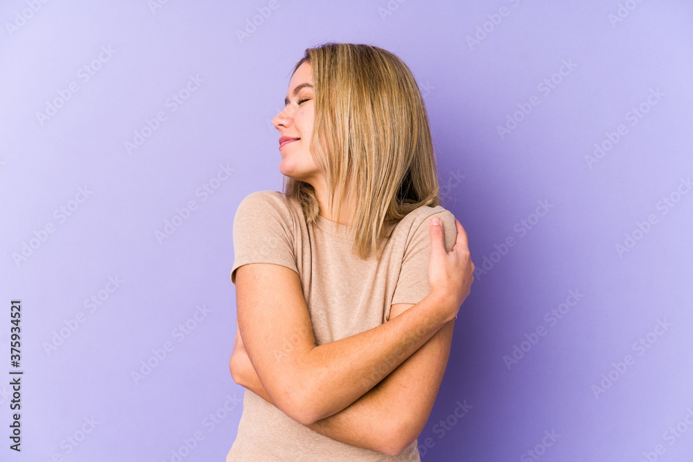 Young blonde caucasian woman isolated hugs, smiling carefree and happy. Young blonde caucasian woman isolated hugs, smiling carefree and happy.