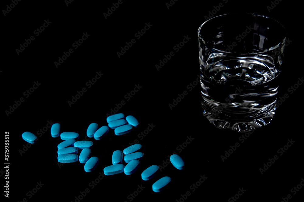Tablets with a glass of water and packaging
Tablets with a glass of water and packaging