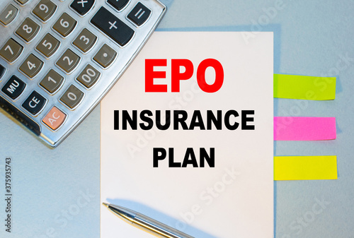 EPO INSURANCE PLAN is written on a notepad next to multicolored stickers, a calculator and a pen on a blue background. Business concept
