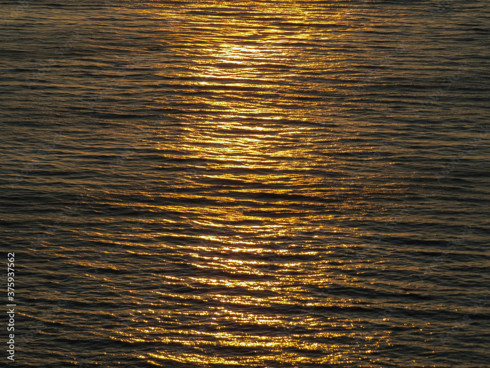 Sunset over water. Ripples on the water with the reflection of sunlight. Sunset over water. Ripples on the water with the reflection of sunlight.