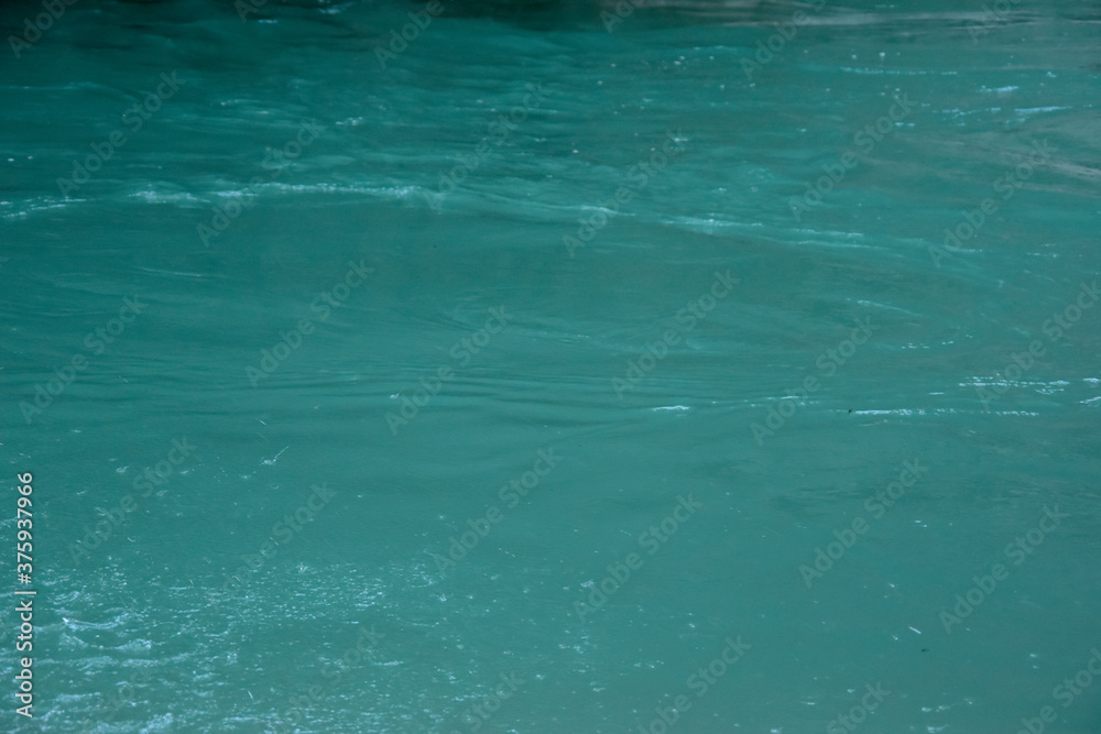 Turquoise background of natural natural source - rivers. The water of the lake shows a natural natural background. Turquoise background of natural natural source - rivers. The water of the lake shows a natural natural background.