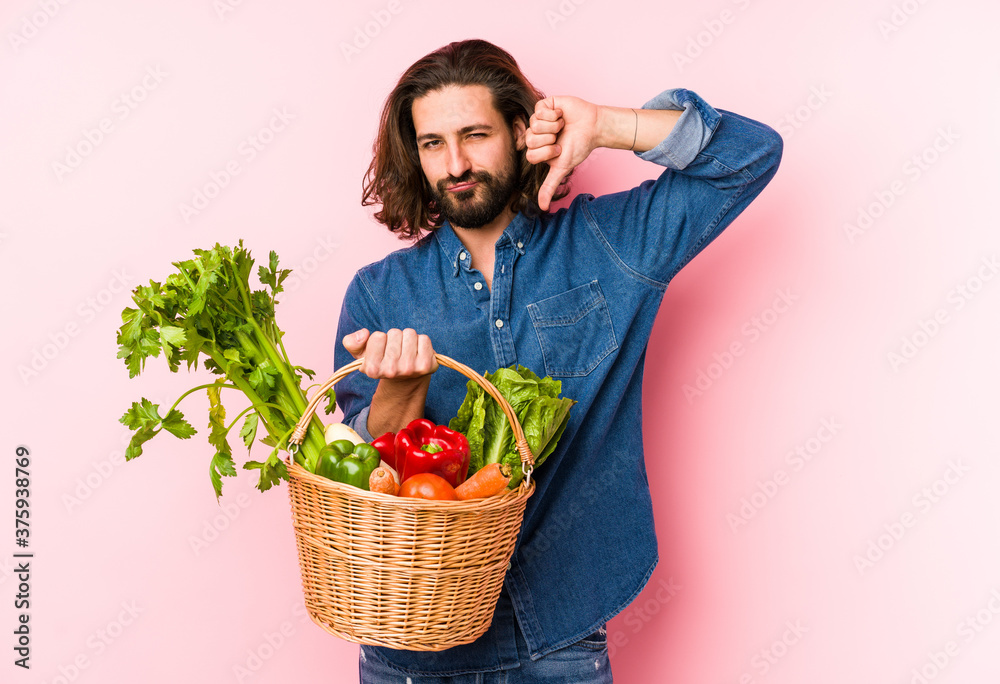 Young man picking organic vegetables from his garden isolated feels proud and self confident, example to follow. Young man picking organic vegetables from his garden isolated feels proud and self confident, example to follow.