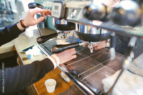 barista man is preparing coffee machine for making espresso.Close up view of men's hand 