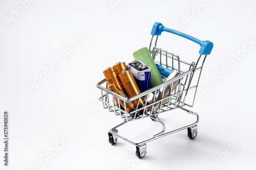 Alkaline batteries in a shopping trolley on a white background. Kholmogory, Russia - August 14 2020. photo