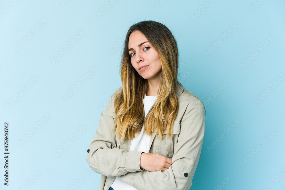 Young caucasian woman isolated on blue background unhappy looking in camera with sarcastic expression. Young caucasian woman isolated on blue background unhappy looking in camera with sarcastic expression.