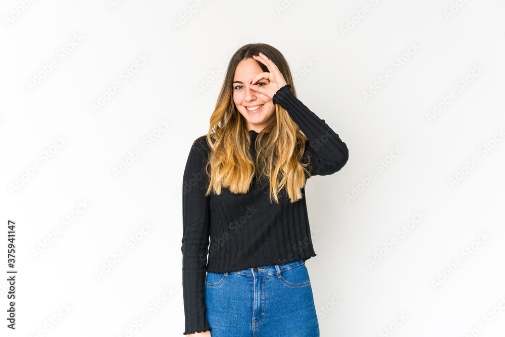 Young caucasian woman isolated on white background excited keeping ok gesture on eye. Young caucasian woman isolated on white background excited keeping ok gesture on eye.