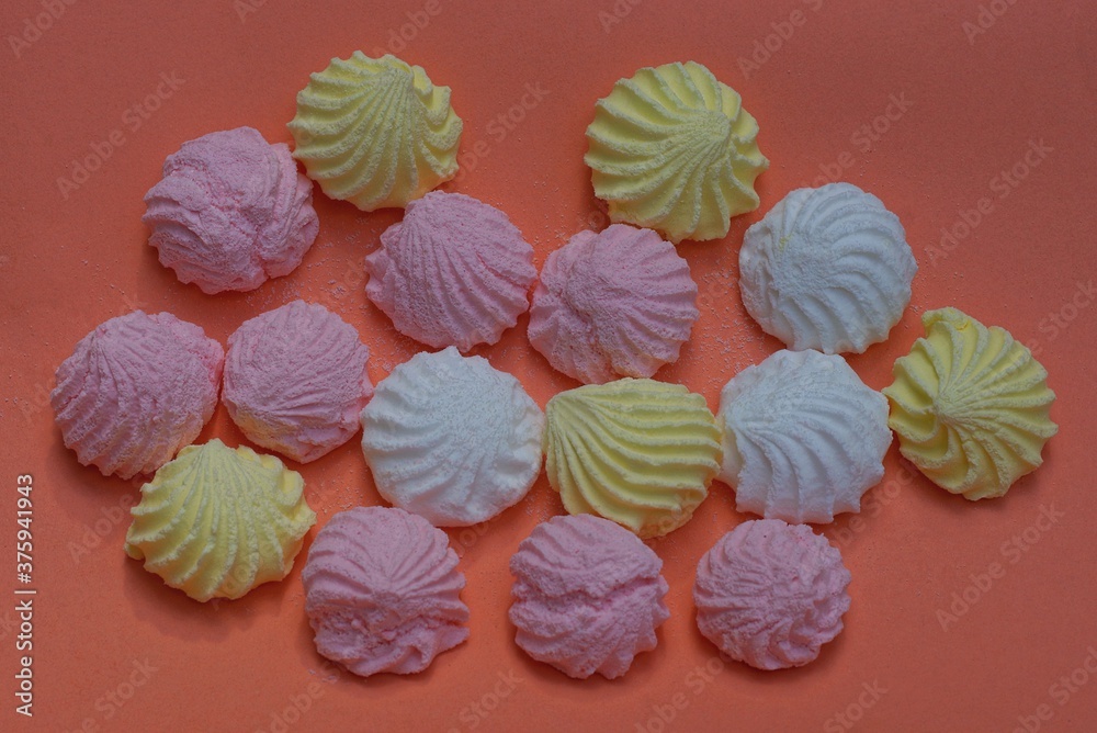 food from round colored marshmallow candies lie on a pink table food from round colored marshmallow candies lie on a pink table