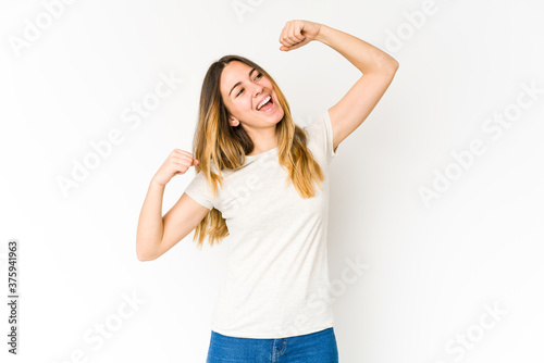Young caucasian woman isolated on white background celebrating a special day, jumps and raise arms with energy. © Asier