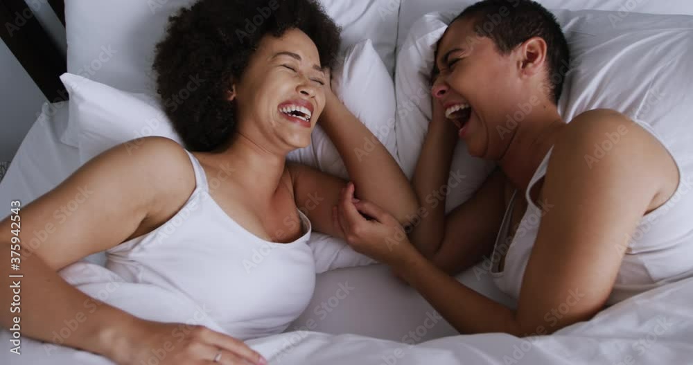 Lesbian couple romancing in bedroom Lesbian couple romancing in bedroom