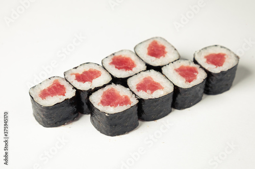 Sushi roll with tuna on a white plate, classic Japanese sushi. Traditional Japanese food with maki Delicious pieces of sushi For the restaurant menu. copyspace.