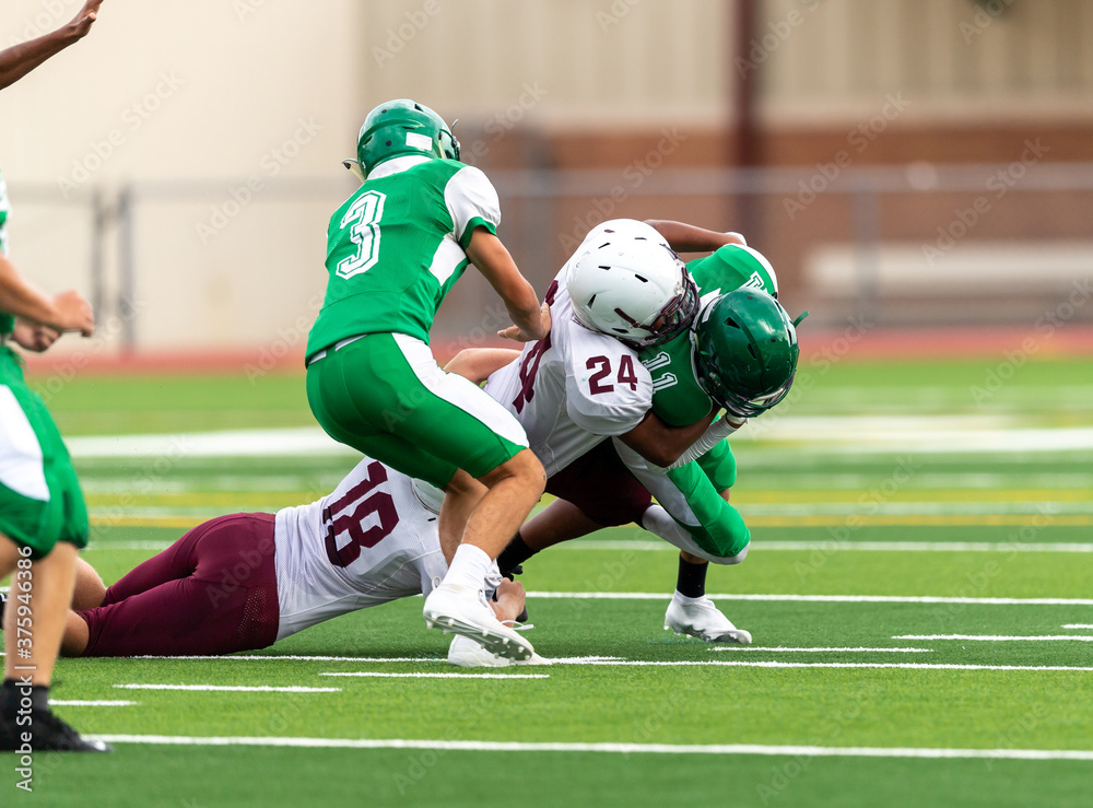 Fototapeta premium Amazing athletes making great catches and runs during a competitive football game