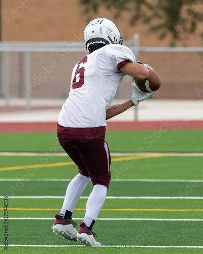 Amazing athletes making great catches and runs during a competitive football game