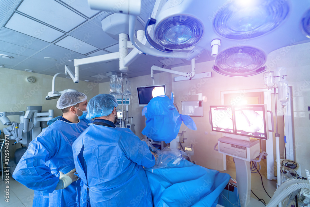 Operation in hospital. Health care concept. Surgeons team working. Selective focus. Medical room background. Operation in hospital. Health care concept. Surgeons team working. Selective focus. Medical room background.