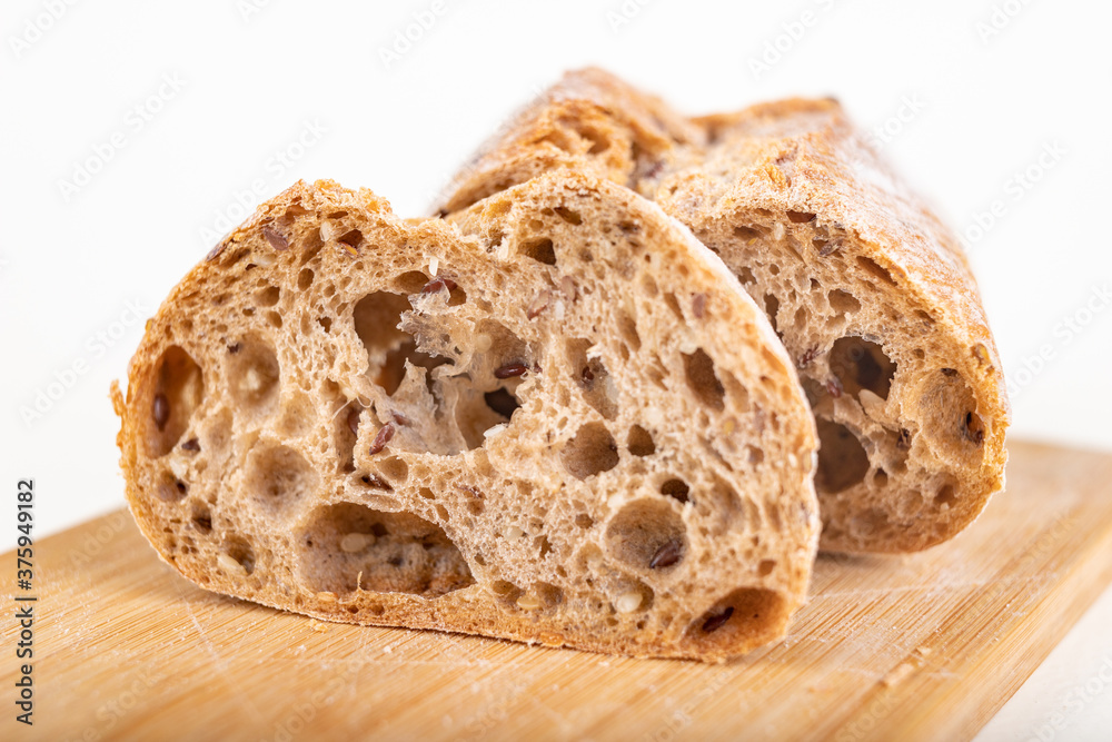 Tasty fresh sliced bun on a kitchen board. Bread prepared for eating in the household. Tasty fresh sliced bun on a kitchen board. Bread prepared for eating in the household.