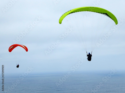 Paragliders flying over the sea