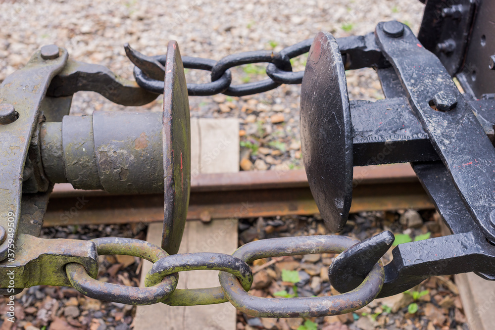 Three-link locomotive chain coupler (rolling stock connection) close up detail. Basic type of coupling on railways (buffer and chain) Three-link locomotive chain coupler (rolling stock connection) close up detail. Basic type of coupling on railways (buffer and chain)