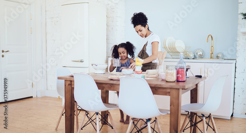 Mother and daughter cooking meal together